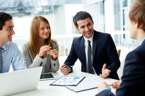 A title agent meets with clients at a house closing.