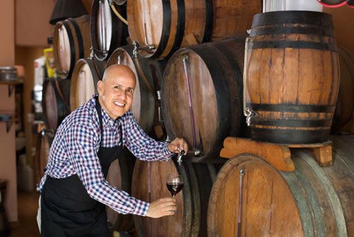 A distiller tries a sample of liquor