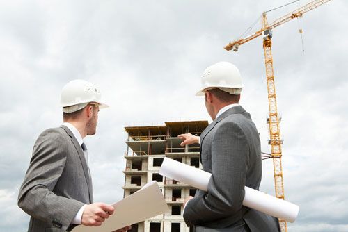 Contractors check the progress of a construction project