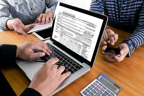 A tax preparer works with a client.