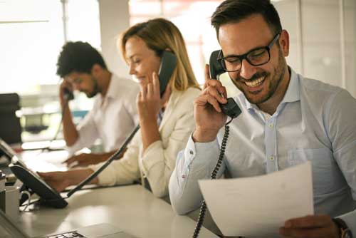 A telephone solicitor speaks with a customer on the phone.