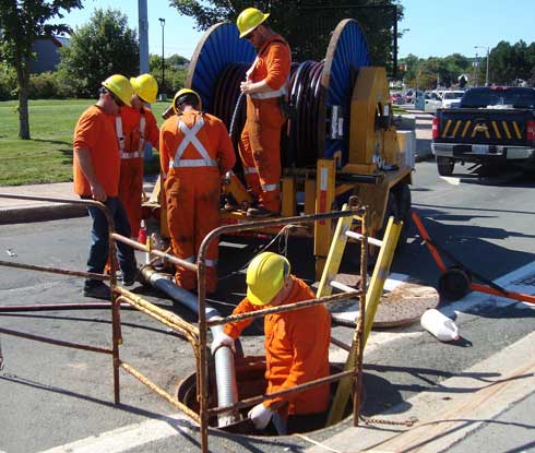 Water and sewer contractors work on a street project